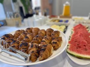 a plate of food on a table with watermelon at Ragusa Villa in Stolac