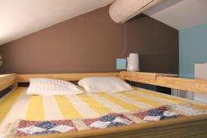 a bedroom with a bed with two pillows on it at Mas Aubert in Eyragues +33 photos