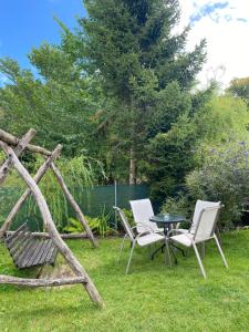 two chairs and a table in a yard at Borkówka in Choczewo