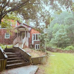 a brick house with stairs leading to a porch at Quiet Cozy Stay Spacious Home Near Beach & Shops in Hamden