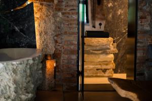 a room with a brick wall and a stack of towels at World Studio Sibiu in Sibiu