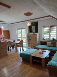 a living room with a couch and a table at Apartman Denis Una in Lužine