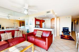 a living room with a red couch and a kitchen at Sea Colony - 509 Dover House Rd. in Bethany Beach