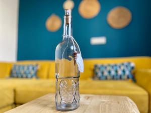 a bottle on top of a wooden table at El descanso de Bielo Lanzarote in Caleta de Caballo