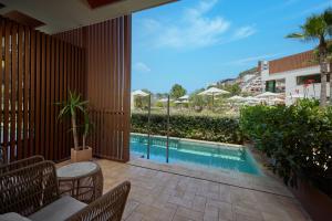 a view of a swimming pool from the patio of a house at Cala San Miguel Ibiza Resort, Adults only, Curio Collection by Hilton in Puerto de San Miguel