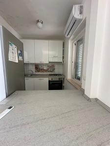 a kitchen with white cabinets and a stove at La casa del Tramonto in Praia a Mare +41 photos