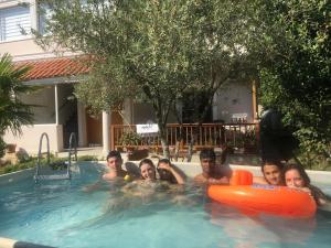 a group of people in a swimming pool at Vila M Vera Rooms with kitchen and Apartments in Durrës