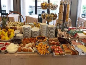 a table with many different types of food on it at Luna Hotel Rimini in Rimini