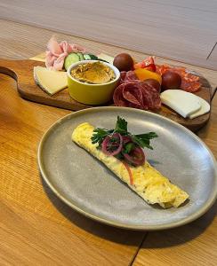a plate with a piece of food on a table at Studio Sonia - Tordosan Central - #3 in Sibiu