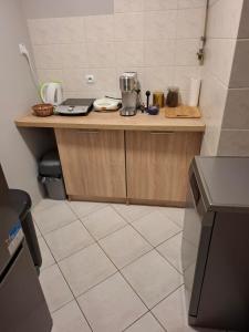 a kitchen with a counter with a laptop on it at Apartament Sopotkowo "WYJĄTKOWY" in Sopot +6 photos