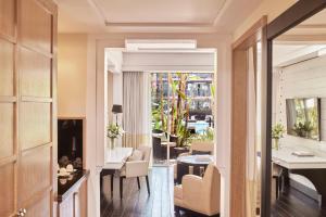 a hallway with a living room and a dining room at Hôtel & Ryads Barrière Le Naoura in Marrakesh