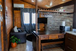 a kitchen with a desk and a computer in a room at Gothes Chalet Javier in Ponte de Vagos