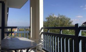 a table and chairs on a balcony with a view at Kantaldi in Guéthary +8 photos