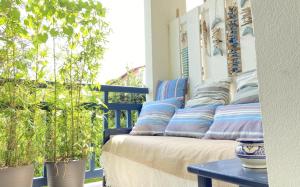 a couch sitting on a porch with potted plants at Kantaldi in Guéthary