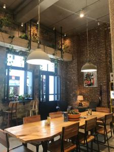a dining room with wooden tables and chairs at Alley Rooms in Mytilene