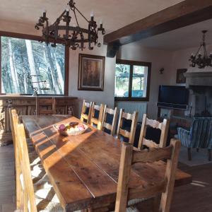 a dining room with a wooden table and chairs at Villa el Pavo Real Arezzo in Arezzo