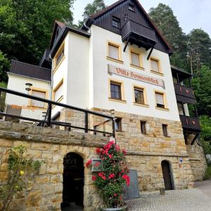 a building on top of a stone wall at Villa Sonnenblick in Kurort Rathen