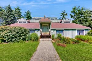 a house with a green door and stairs leading to it at Four Seasons Retreat in Bartlett