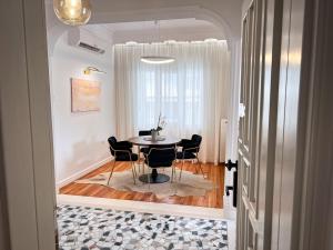 a dining room with a table and chairs at CASA BIANCA Kastoria in Kastoria