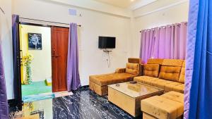a living room with a couch and a coffee table at Himaksh Homestay in Varanasi