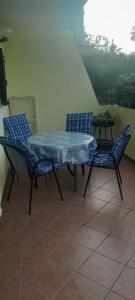 a table and two chairs and a table and a table at Apartment Djanina in Cres +10 photos