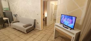 a living room with a flat screen tv on a table at Casa di Giotu in Villanova dʼAsti
