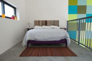 a bedroom with a bed and a colorful wall at Modern architecture with great view in San Agustín Etla