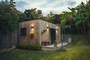 a small wooden shed with a door in a yard at Modern architecture with great view in San Agustín Etla
