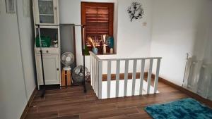a room with a staircase with a rug on a wooden floor at Tisno Stone House on the Cove in Tisno