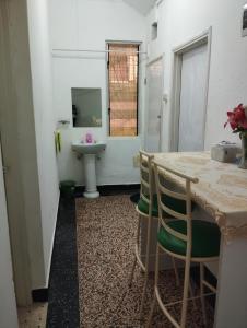 a bathroom with a sink and a table and chairs at Mombasa Comfort House, Old Town in Mombasa +52 photos