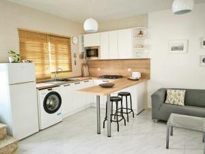 a kitchen with a table and a couch in a kitchen at Casa Belén in Pozo Negro +11 photos
