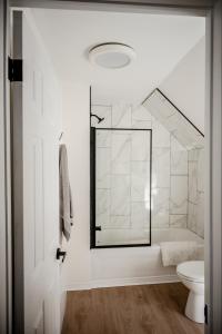 a bathroom with a shower and a toilet at The cozy place in Campbellton +8 photos