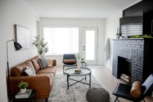 a living room with a couch and a fireplace at The cozy place in Campbellton