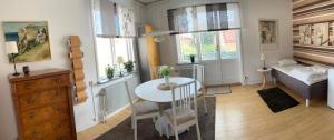 a small living room with a table and a bedroom at Stensötan in Örebro