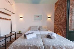 a bedroom with a bed with two pillows on it at ºººººPS New Atocha City Centre WiFi AC SmartTVººººº in Madrid +14 photos
