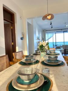 a table with plates and bowls on top of it at Marina Beachfront at JUMEIRAH PALM RESORT-NYALI in Mombasa