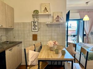 a kitchen with a table with flowers on it at Spacious Studio Apartment with Terrace in Perugia