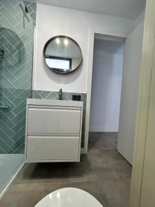 a bathroom with a white sink and a mirror at SWeeT HOME NAOS in Puerto Naos +30 photos
