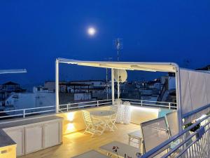 a deck with a table and chairs on a balcony at The Sorabellas in Gaeta