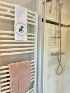 a bathroom with a shower and a towel on a towel rack at La Grenouillère - Chambre d'hôtes de charme in Ballan-Miré +55 photos