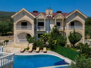 a large house with a swimming pool in front of it at Dapaj Luxury Residence in Vlorë