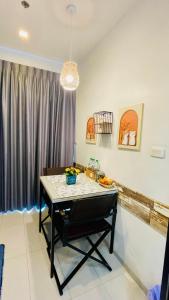 a dining room with a table with a bowl of fruit on it at The base Central Pattaya 338 by Numam in Pattaya
