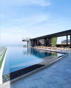 a swimming pool in front of a building with water at The base Central Pattaya 338 by Numam in Pattaya