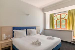 Кровать или кровати в номере B&B Hotels Park Hotel Suisse Santa Margherita Ligure
