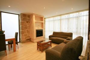 a living room with a couch and a table at Casa en Fontecova in Cuntis