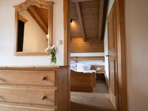 a bedroom with a mirror and a bed in it at Müller Nr 2 in Kirchberg in Tirol