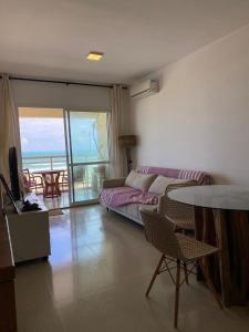 a living room with a couch and a table at VG Fun Beach Front Apartamentos in Fortaleza