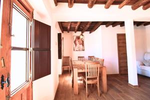 a dining room with a wooden table and chairs at El Pintaillo by SIERRA VIVA in Cortelazor +17 photos