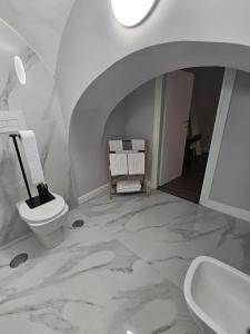 a white bathroom with a toilet and a sink at Napoli the charme in Naples