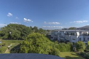 an apartment building on a hill with trees at Stylish 2BR Apt with Balcony & Views near Center in Luxembourg
